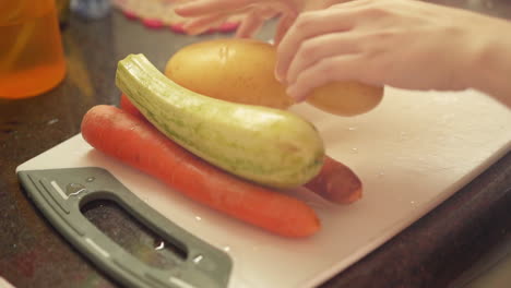 Female-hands-putting-vegetables-and-ingredients-on-cutting-board