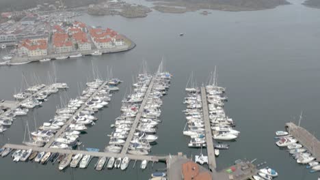 Drone-flight-over-a-yacht-harbour-in-Marstrand,-Sweden