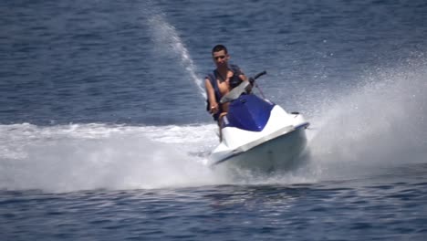 Young-man-riding-fast-high-speed-Jetski-in-summer-sea-in-Slow-motion-action-shot