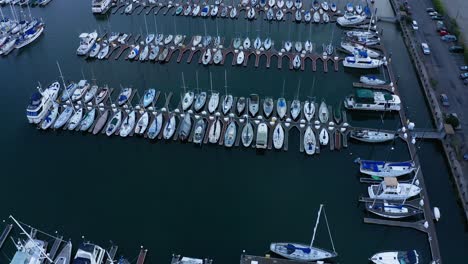 A-very-large-dock-with-a-marina-and-sail-boats-in-slips