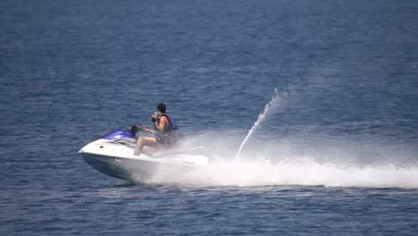 Man-riding-Jetski-in-mediterranean-sea-jumping-over-water-in-Slow-motion-action-shot