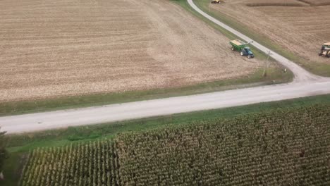 Drone-flyover-view-of-a-green-cornfield-towards-a-harvested-cornfield