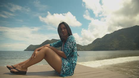 A-sexy-venezuelan-model-posing-on-the-jetty-in-a-Caribbean-fishing-village-of-Maracas,-Trinidad
