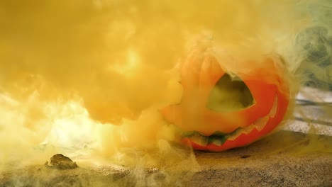 Bright-orange-smoke-clears-to-reveal-classic-jack-o-lantern-on-a-porch