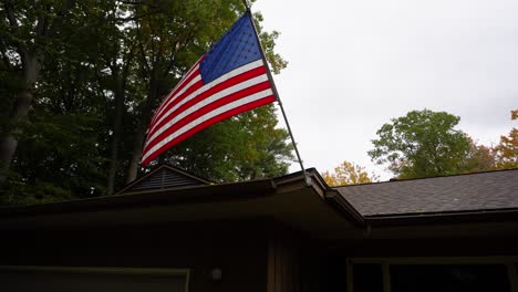 Shot-of-an-American-Flag-blowing-in-the-wind-of-a-fall-storm-in-Michigan,-USA