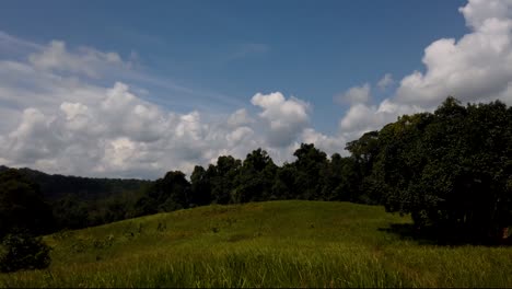 Landscape-in-Khao-Yai-National-Park,-Trees-and-Mountains-with-fluffy-big-Clouds-Casting-Shadows