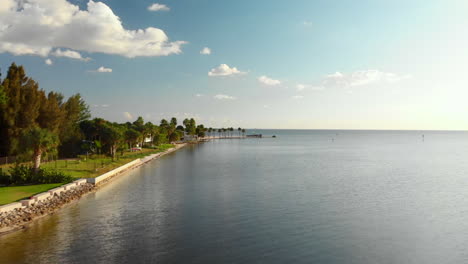Aerial-flying-low-past-idyllic-seaside-houses-towards-sandy-point,-Pine-Island,-Florida