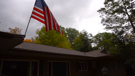 Shot-of-an-American-Flag-blowing-in-the-wind-of-a-fall-storm-in-Michigan,-USA