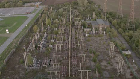 Rising-reveal-of-a-derelict-power-station-surrounded-by-nature-regrowing
