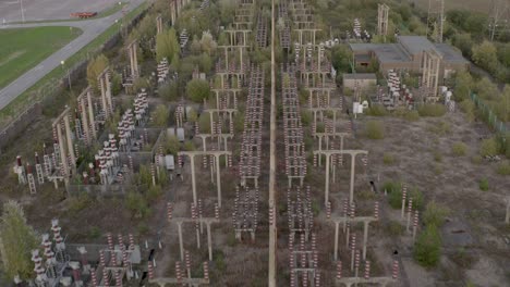 Fly-over-power-station-in-a-state-of-decay-and-nature-regrowth-surrounding-it