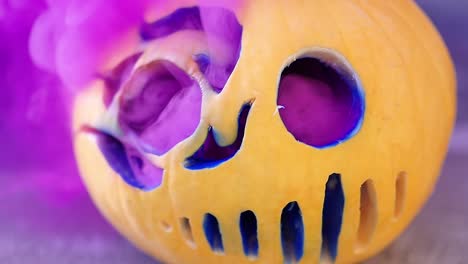 Close-up-of-serial-killer-mask-jack-o-lantern-with-bright-pink-smoke-coming-out-from-inside