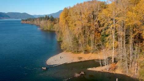 Drone-shot-of-lake-,forest-and-mountains-in-autumn-on-Cowichan-Lake-,Vancouver-Island,-Canada
