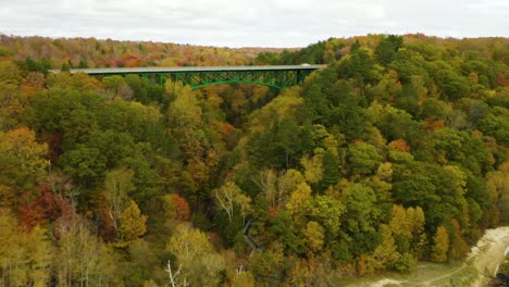 Aerial-push-in-towards-green-bridge-in-Michigan's-Upper-Peninsula