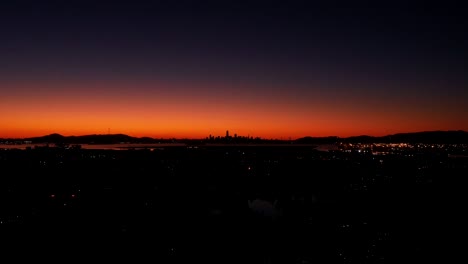 A-fast-time-lapse-of-the-sunset-behind-the-urban-city-and-the-traffic-below