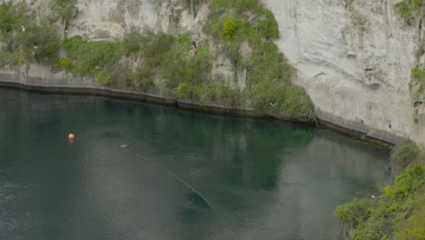A-tracking-shot-of-someone-bungy-jumping-from-a-platform-over-the-Waikato-river-in-Taupo,-NZ