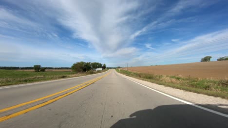 Point-of-view-footage-while-driving-down-a-paved-road-in-rural-Iowa