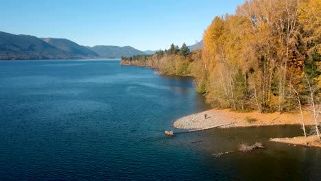 Drone-shot-of-lake-,forest-and-mountains-in-autumn-on-Cowichan-Lake-on-Vancouver-Island,-Canada