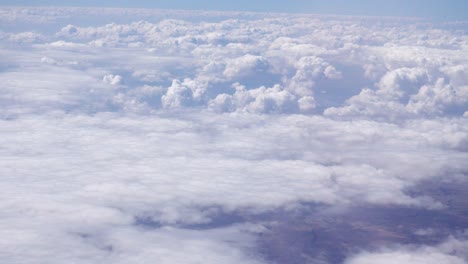 View-of-dense-white-clouds-seen-from-the-window-of-a-passenger-plane