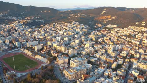 Aerial-drone-Flight-descending-to-mitilini,city-center-houses-turning-to-hills-and-mountains,-mytilene-lesvos,-greece
