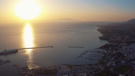 Aerial-drone-flying-around-mitilini,-harbor-and-sea-to-turkish-coast-with-ferry-to-athens,-mytilene-lesvos,-greece