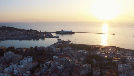Drone-Sunrise-View-Of-The-mediterranean-sea-Water,-ferry-to-athens-in-lesvos,-Greece---mitilini-harbor-Aerial