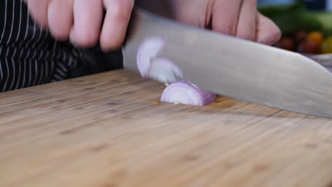 woman-cutting-onions-on-the-wooden-table
