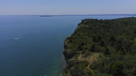 Aerial-shot-closing-in-and-flyby-to-the-cliffs-of-Manerba-at-Lago-Di-Garda-on-a-bright-sunny-day