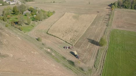 Aerial-over-farm-field-on-sunny-day,-pedestal-movement