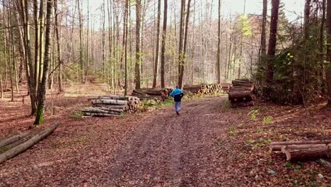 Man-Running-on-a-Forest-Trail-in-Autumn-Scenery