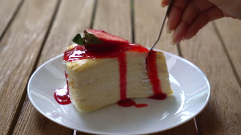 vanilla-crape-cake-with-strawberry-sauce-in-cafe