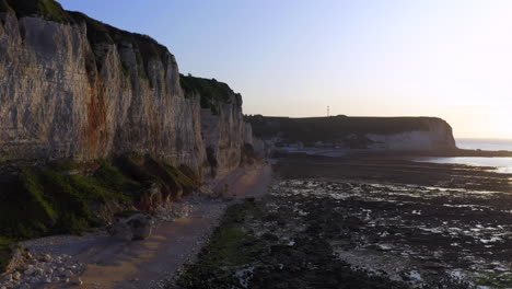 Ascending-aerial-shot-over-the-steep-cliff-of-the-french-Normandy-at-sunset