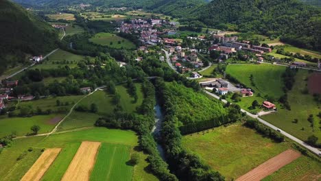 Forward-drone-shot-above-Ponte-San-Quirino-fields-and-mountains,-Italy