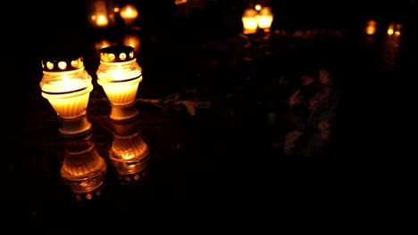 Cemetery-grave-burning-candle-at-all-souls-day,-dark-night-and-spooky-atmosphere,-rip