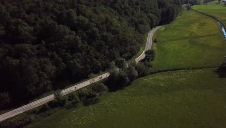 Aerial-shot-of-a-road-surrounded-by-fields,-near-Kobarid,-Slovenia