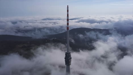 Aerial-flyby-shot-of-a-big-broadcasting-tower-on-the-black-forest-mountain-Hornisgrinde