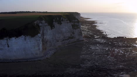 Descending-aerial-shot-over-the-steep-cliff-of-the-french-Normandy-at-sunset
