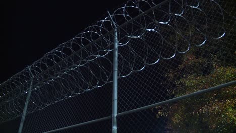 BARB-WIRE-FENCED-JAIL-AT-NIGHT