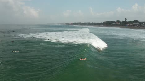 Surfing-on-Waves-of-Indian-Ocean-Aerial,-Surfers-on-Bali-Island,-Indonesia,-Canggu-Beach