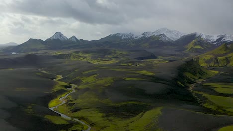 A-drone-video-from-the-Highlands-of-South-Iceland-showing-black-sands,-green-moss-and-snow-in-the-mountains