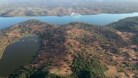 High-Altitude-Forward-Flying-Shot-of-Inhampavala-Lake-in-Chindeguele-Mozambique-During-Golden-Hour-Sunrise