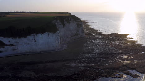 Descending-aerial-shot-over-the-steep-cliff-of-the-french-Normandy-at-sunset