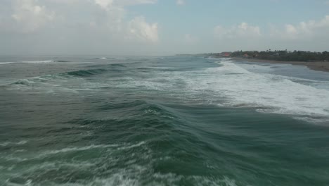 Rough-Indian-Ocean-and-Surfers-Waiting-For-Perfect-Waves,-Cinematic-Aerial