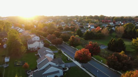 Aerial-panoramic-view-of-neat-community-of-homes-in-Northeastern-USA-during-autumn-sunset