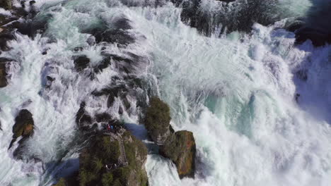 Slow-Motion:-Tracking-shot-of-a-rock-sitting-in-the-roaring-waterfall-Rheinfall-at-Schaffhausen-in-Switzerland