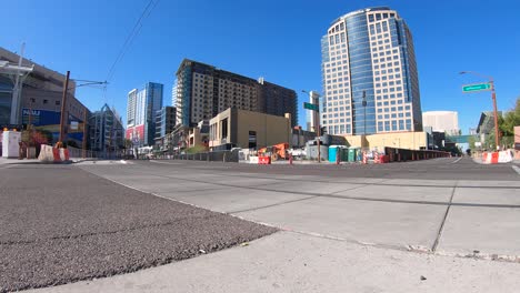 Time-lapse,-a-low-angel-of-traffic-moving-between-high-rises,-on-Washington-Street,-Phoenix,-Arizona