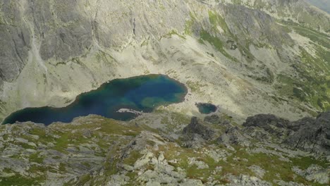 Beautiful-View-of-Amazing-Mountain-Lake-Near-at-Kriváň-in-Slovakia---Aerial-Shot