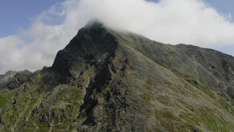 Impressive-Aerial-Krivan-Summit-Slope-and-Ridge-on-Sunny-Cloudy-Day,-High-Tatras