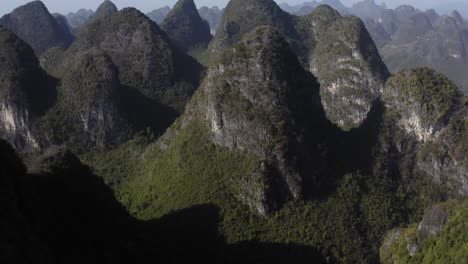 Tilting-aerial-shot-of-an-isolated-mountain-range-in-Yangshuo,-China