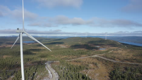 Mighty-Windmills-Harvesting-Wind-Energy-In-The-Countryside-Of-Osen,-Norway-On-A-Bright,-Sunny-Day---Aerial-Moving-Shot
