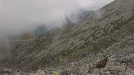 Beautiful-Footage-View-From-Hiking-Trail-To-Krivan-in-Slovakia-With-Fog-Clouds-and-Rocky-Rocks-in-Surrounding---Rolling-Shot